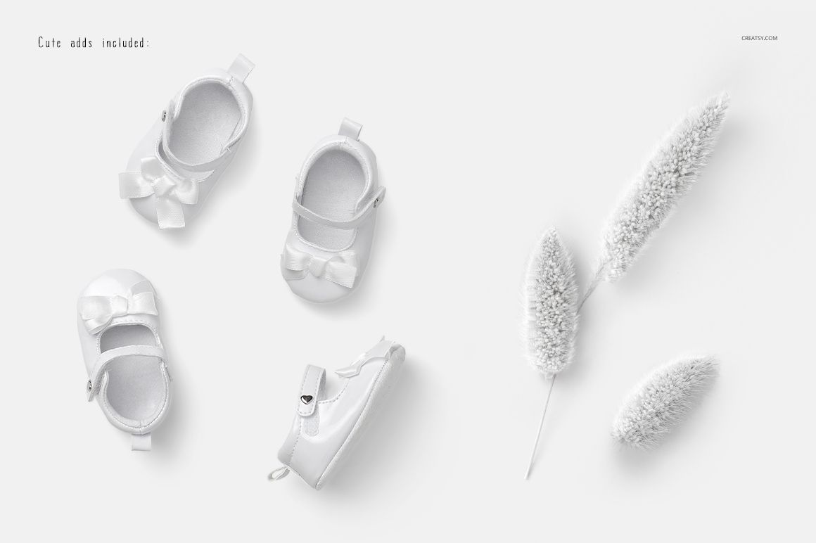 PSD mockup featuring three white baby onesies with bows, shown from above beside white textured botanical props.