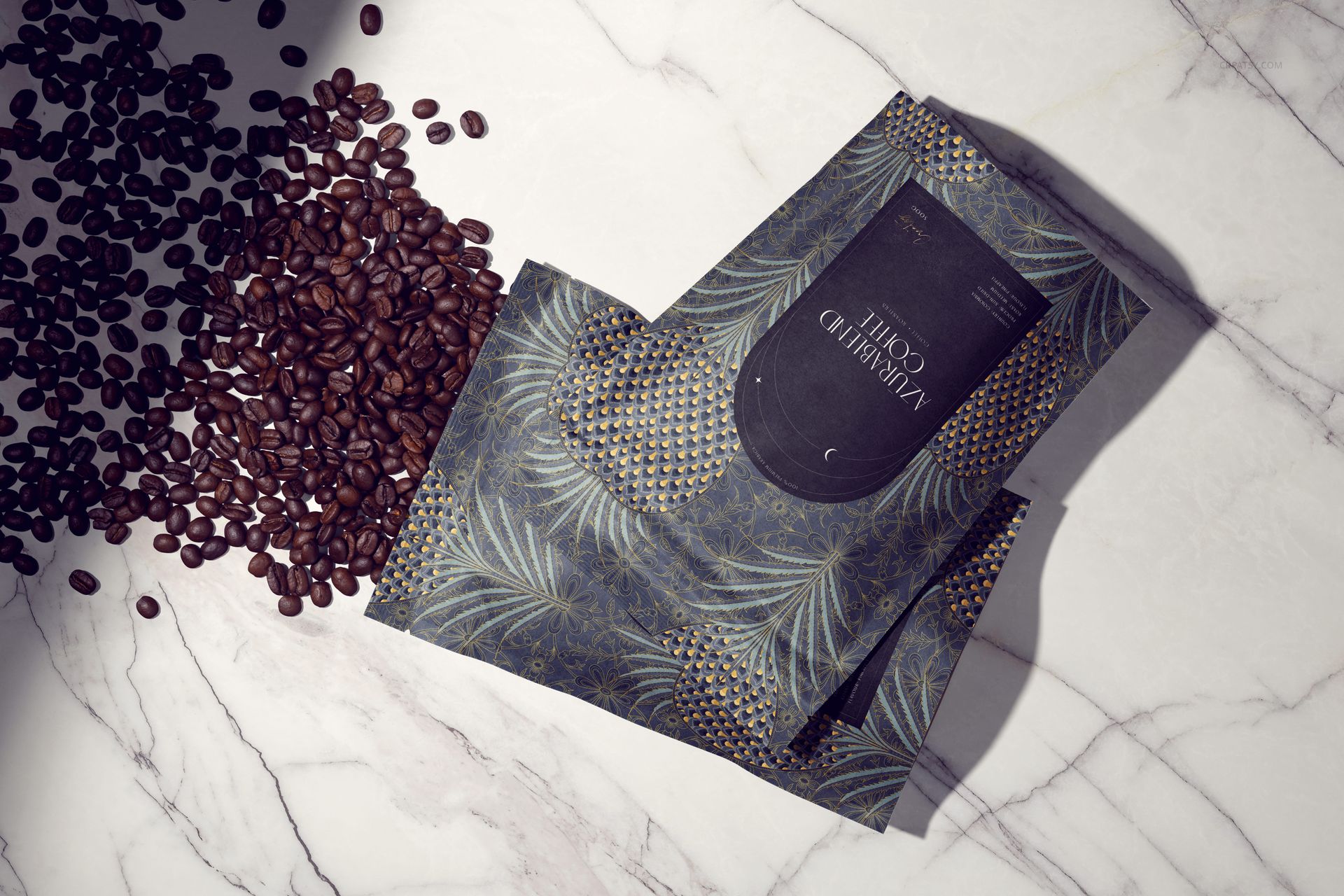 Coffee packaging mockup with dark patterned bags and scattered coffee beans on a white marble surface, top view.
