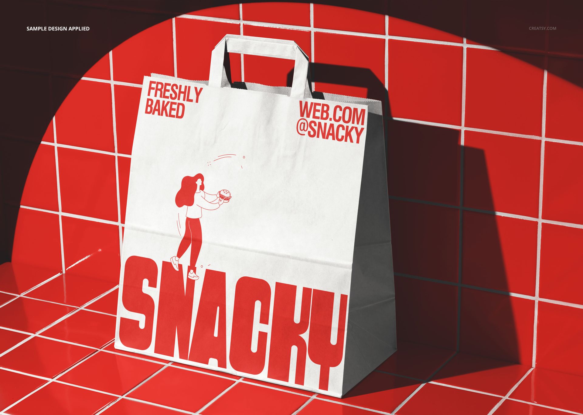 Front view of a fast food paper bag mockup with red artwork, set against a shiny red tile background and dramatic shadows.