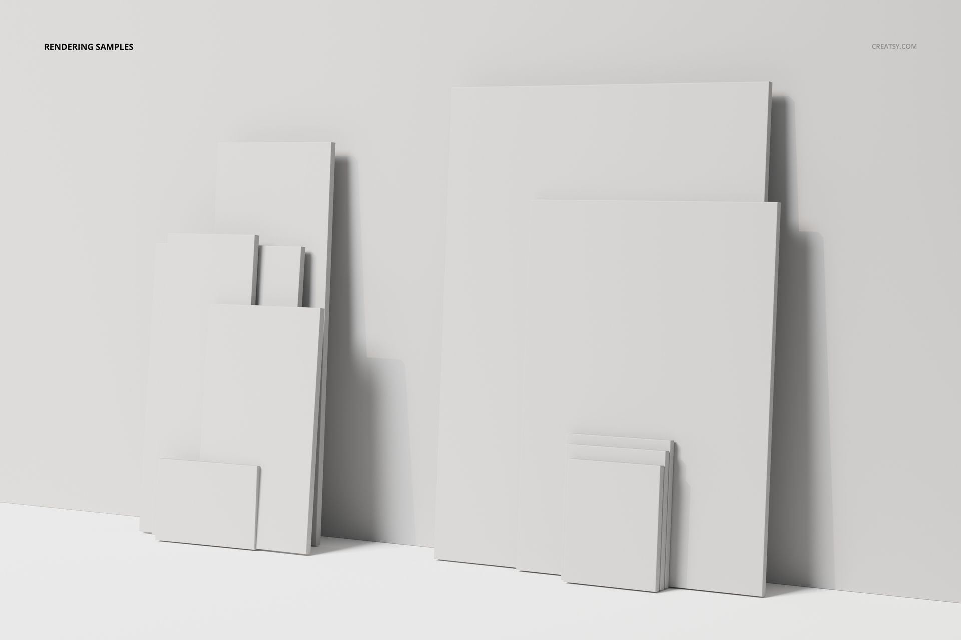 Assorted blank canvas panels in various sizes arranged against a white wall, shown from a front angle in soft light.