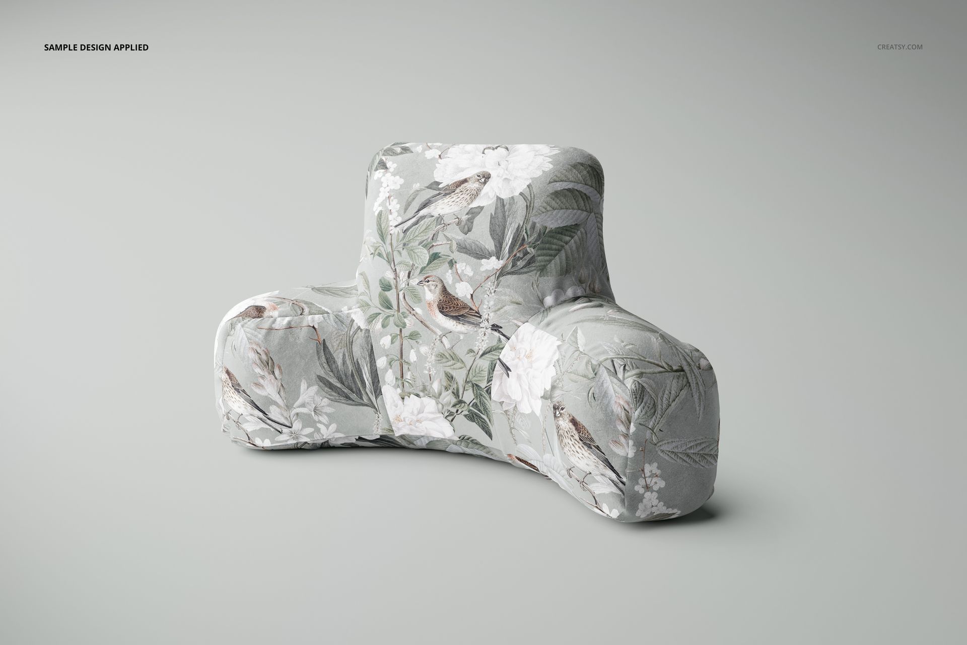 Front view of a velvet and polyester reading pillow mockup with a floral and bird print on a neutral background.
