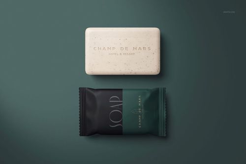 PSD mockup featuring two hotel hand soaps, one unwrapped and one in green and black packaging, top view.