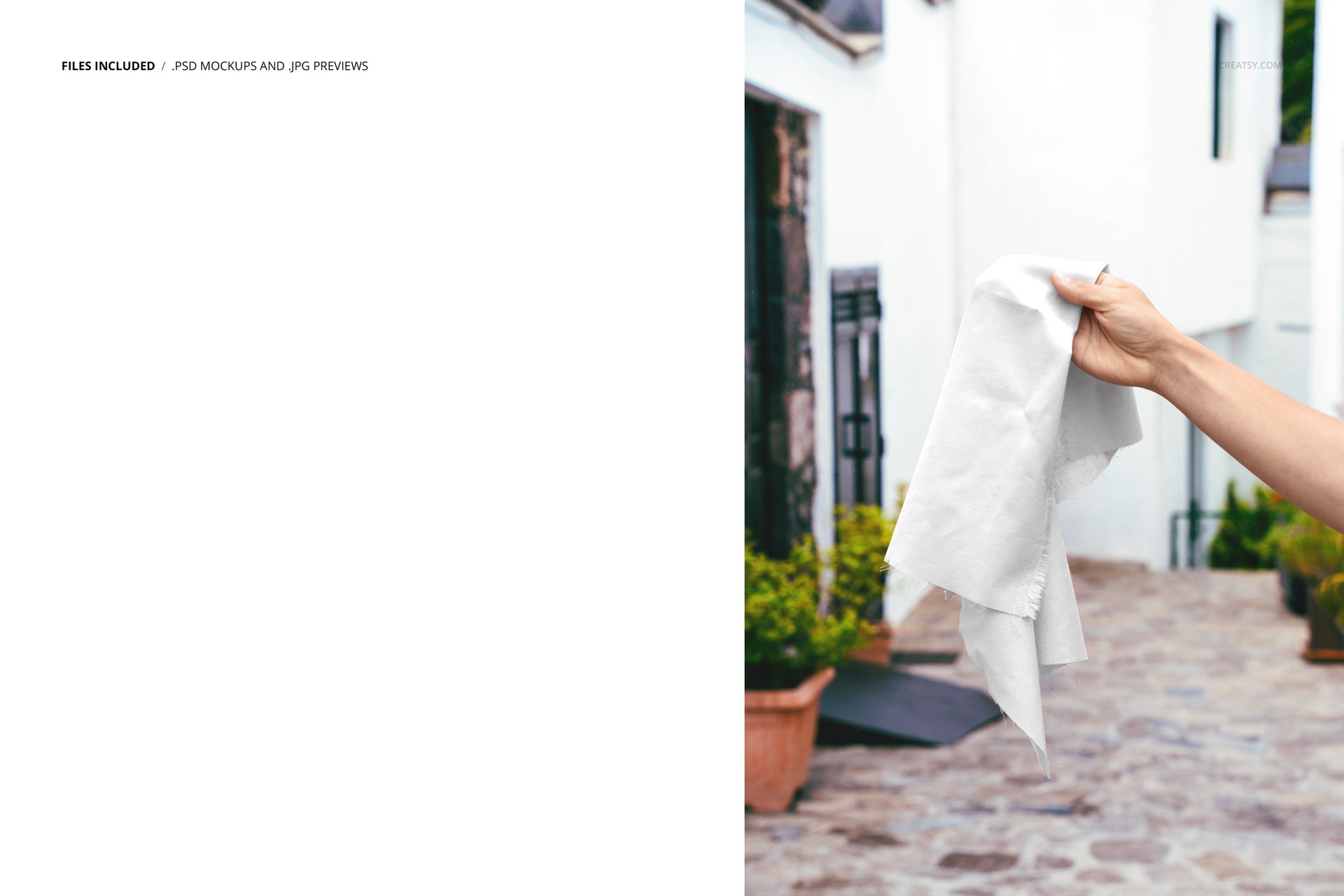 PSD mockup showing a hand presenting a simple white fabric sample outdoors near a white building and cobblestone path.