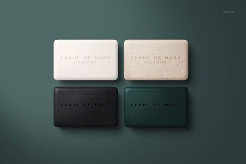 PSD mockup showing four hotel hand soap bars arranged in a grid, each with different solid colors and textures.