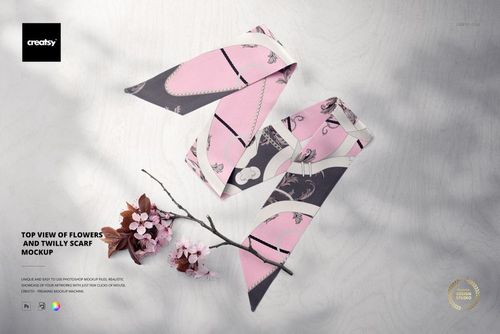 PSD mockup showing two patterned twilly scarves in pink and gray tones, displayed next to cherry blossoms on a pale wooden background.