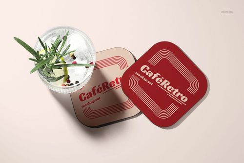 PSD mockup featuring two vintage-style coasters and a cocktail glass, arranged on a softly lit tabletop.