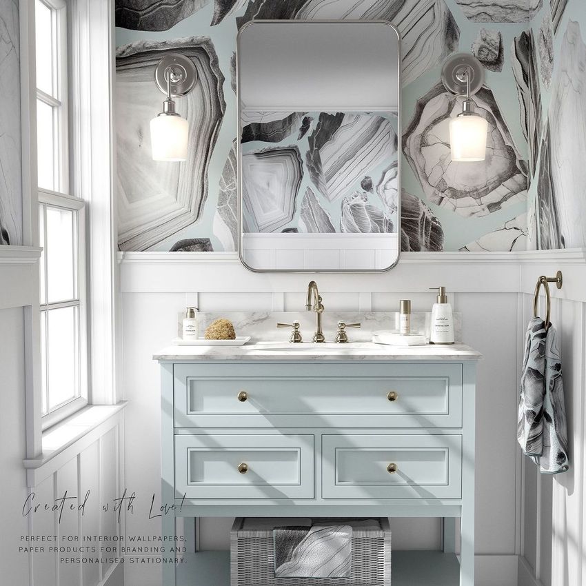 Bathroom mockup featuring a light blue vanity with brass fixtures, marble countertop, and abstract patterned wallpaper in gray tones.