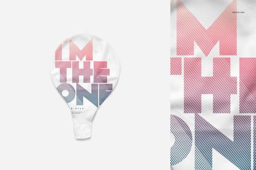 Close-up of a party balloon mockup with bold, diagonal-striped text in pink and blue over a white surface.