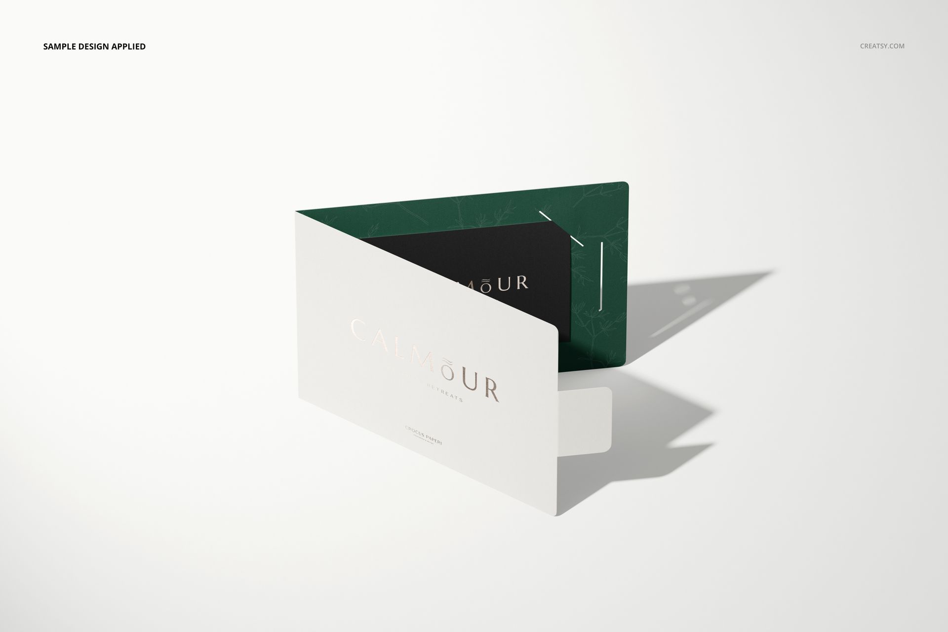 Gift card holder mockup featuring a folded white card with a green interior, displayed on a light surface at an angle.