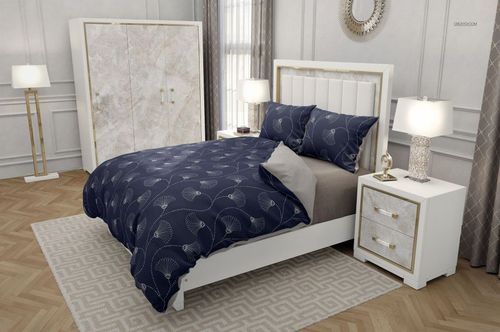 Modern bedroom bedding set with navy blue patterned duvet and pillows, white bed frame, and neutral decor.