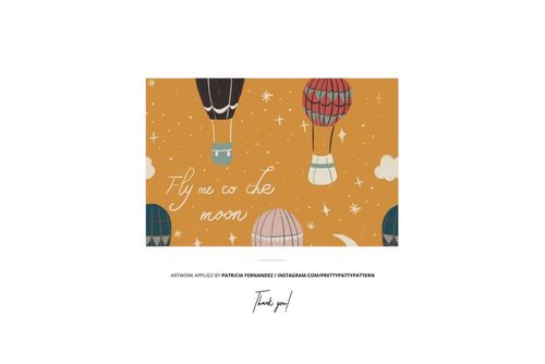 Jersey fabric mockup featuring soft folds and a whimsical hot air balloon pattern on a mustard yellow background.