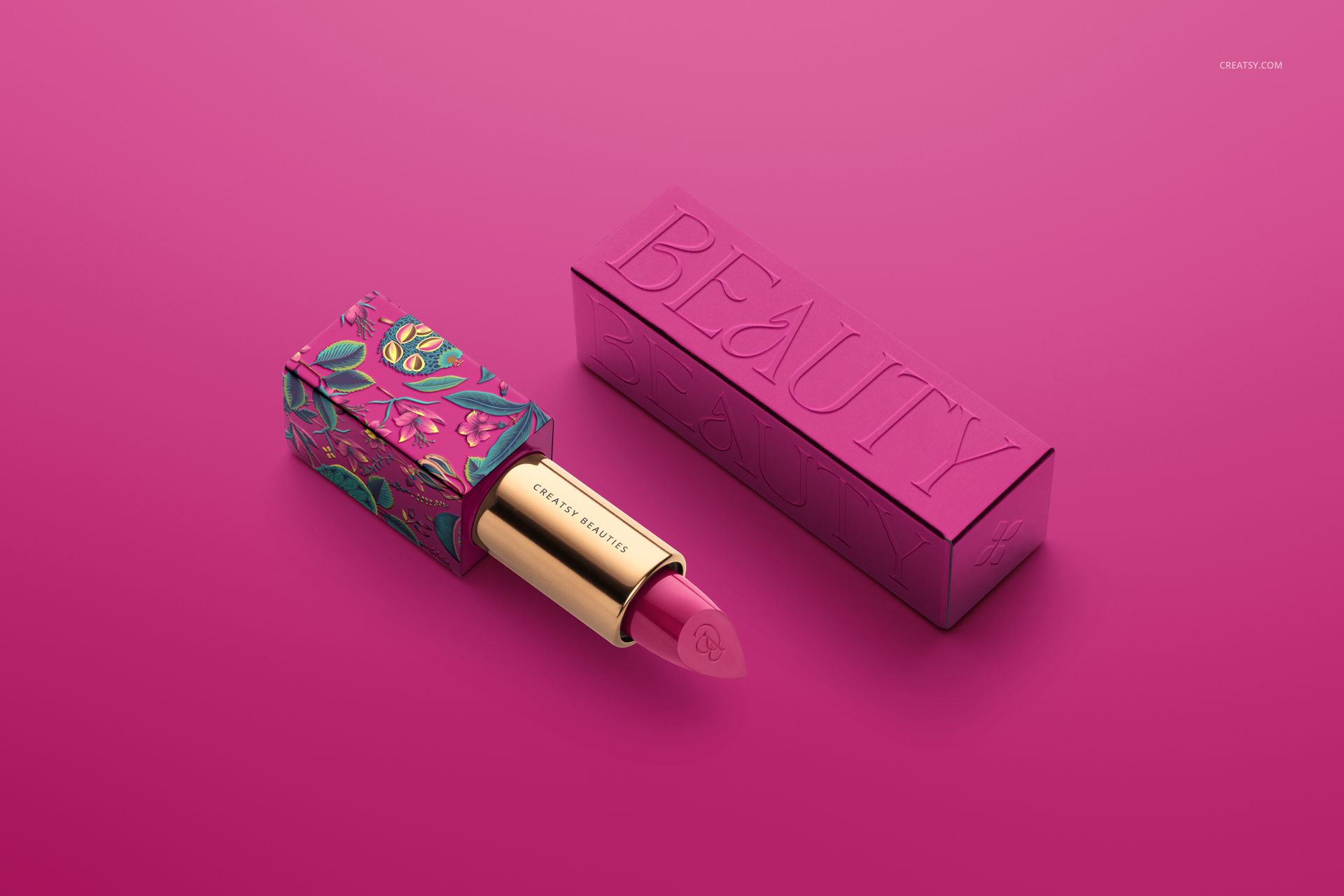 PSD mockup of a classic lipstick in a gold tube with a decorative pink case and box, shown from a front angle on pink.