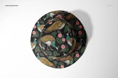 Reversible bucket hat mockup shown from above, decorated with colorful birds and floral elements on a black base.