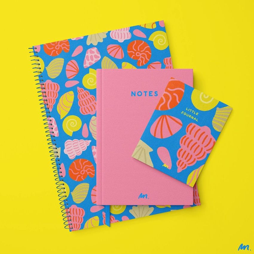 Stationery mockup featuring three notebooks with colorful shell patterns and text, arranged on a bright yellow background.