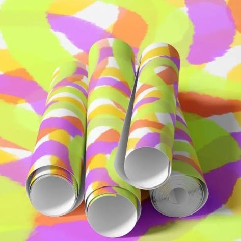 Paper wallpaper mockup showing four rolled sheets with abstract colorful patterns in yellow, pink, orange, and white tones.