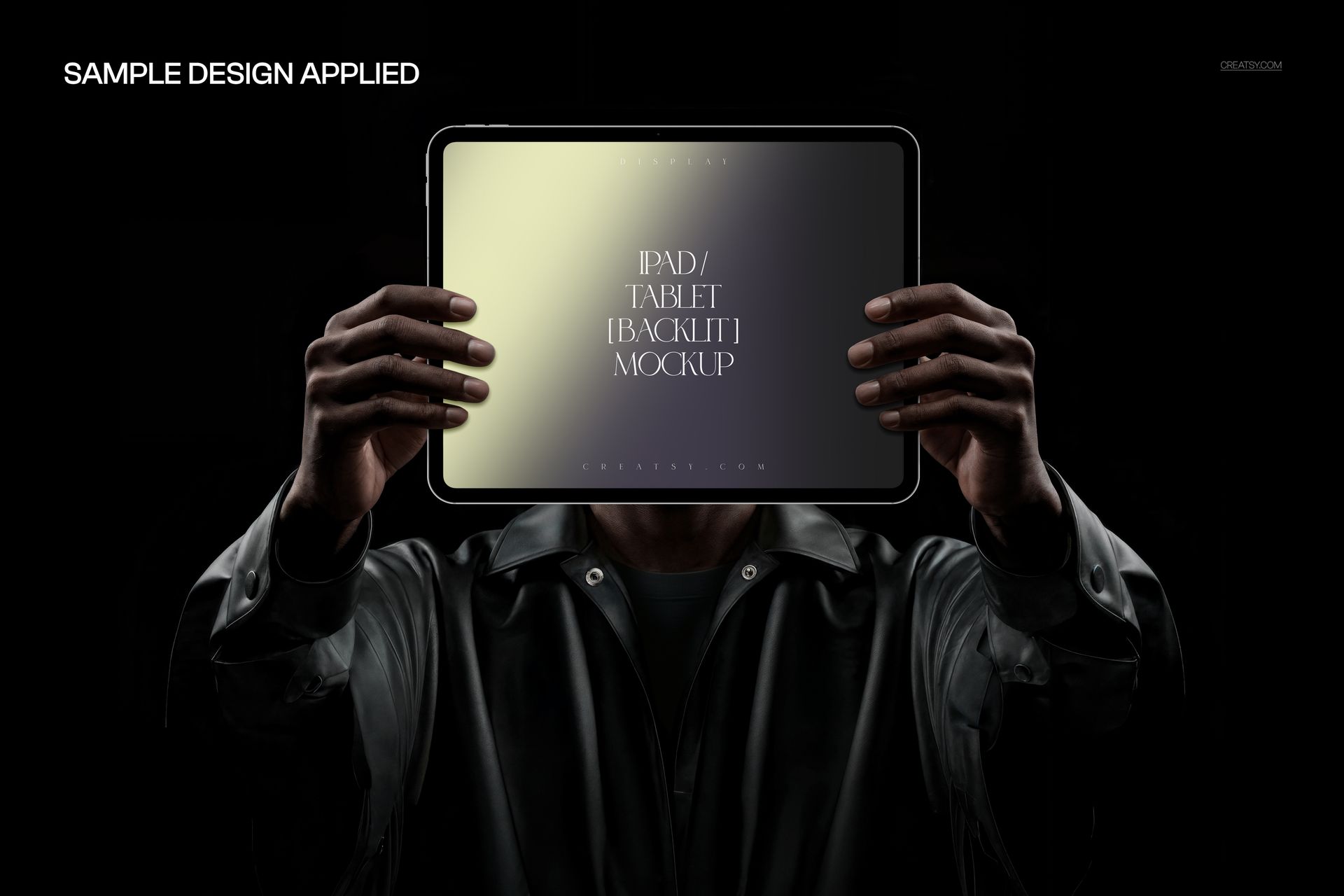 Person holding a backlit tablet mockup in both hands, with gradient colors displayed on the screen against a dark background.