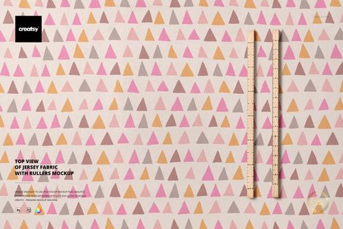 Jersey fabric mockup featuring a repeating triangle design in muted colors, displayed from above with two rulers on the right.