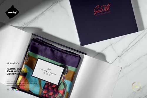 Mockup of a folded silk scarf with multicolor accents in a presentation box, accompanied by a branded card and lid.