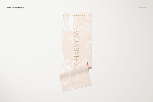 Rolled yoga mat mockup featuring a soft pastel swirl design and metallic lettering, displayed on a clean surface.