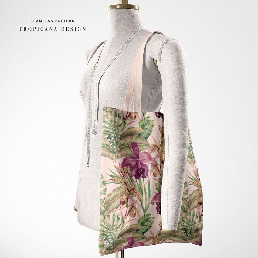 Tote bag mockup featuring a floral tropical pattern in pink and green displayed on a dress form against a plain background.