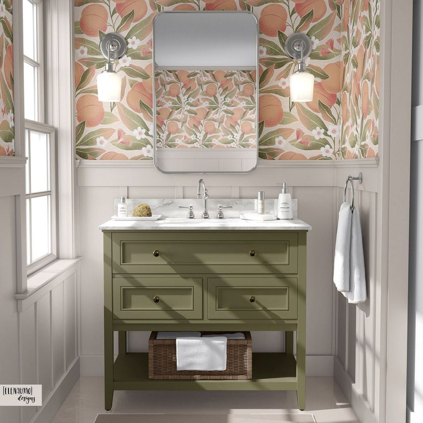 Bathroom mockup showing an olive green vanity with a marble countertop, peach patterned wallpaper, and two wall sconces.