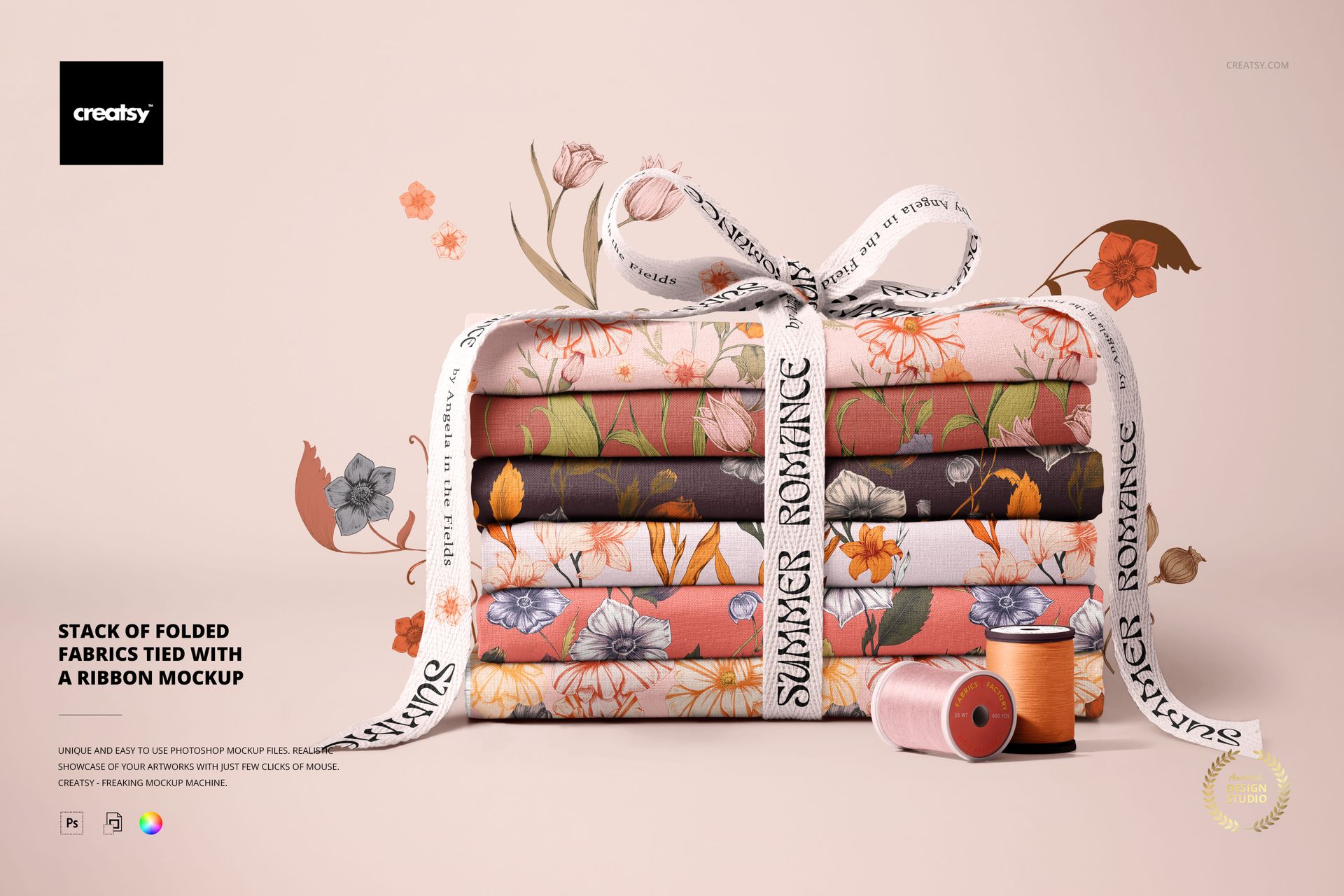 Front view of a PSD mockup showing a bundle of patterned fabrics tied with a ribbon, surrounded by sewing props.