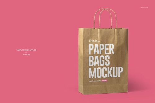 Front view of a brown paper bag with printed text, set against a solid pink background, showcasing mockup design.