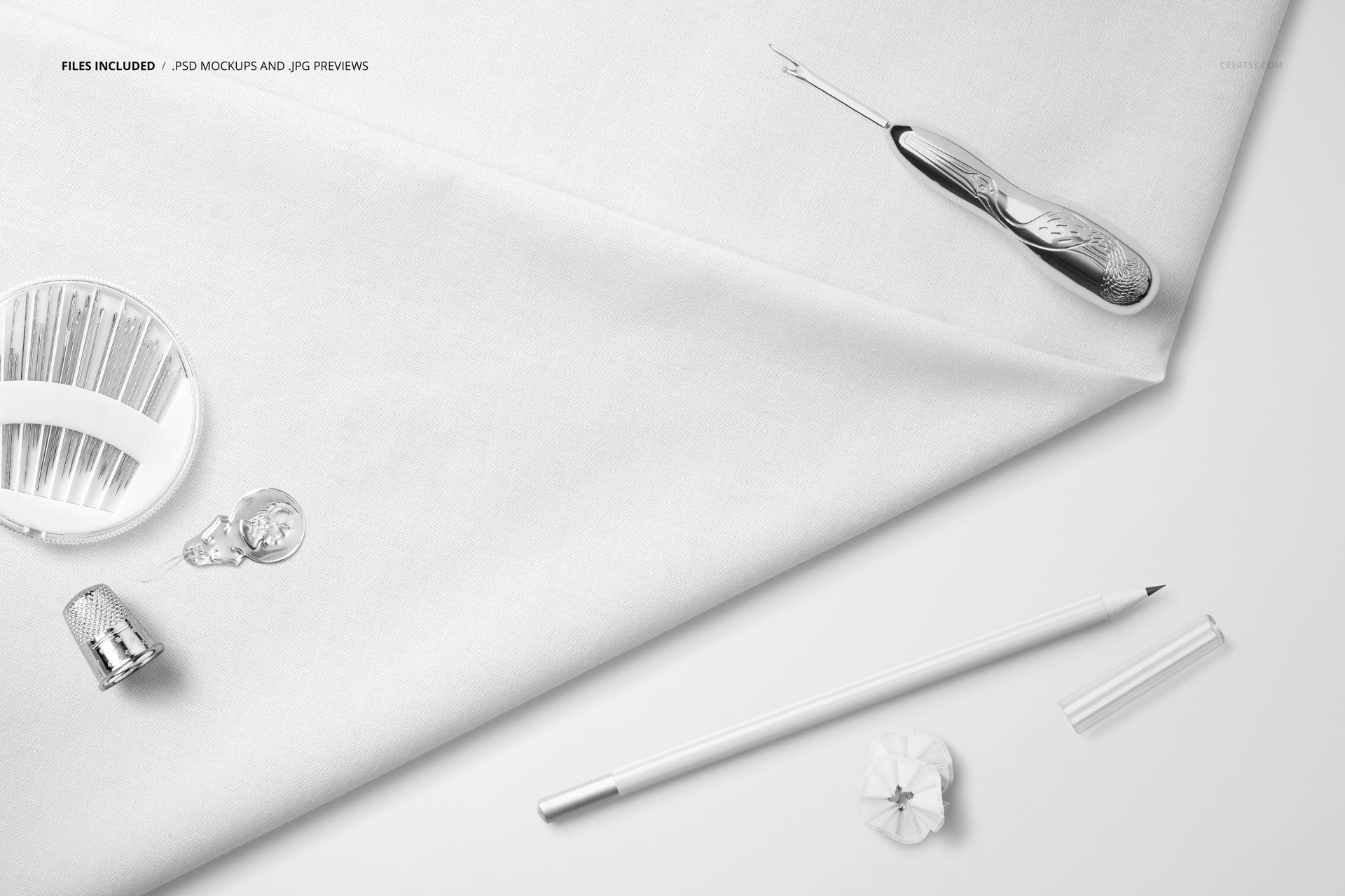 Cotton fabric mockup displayed from a top view, featuring a seam ripper, pencil, thimble, and sewing accessories.