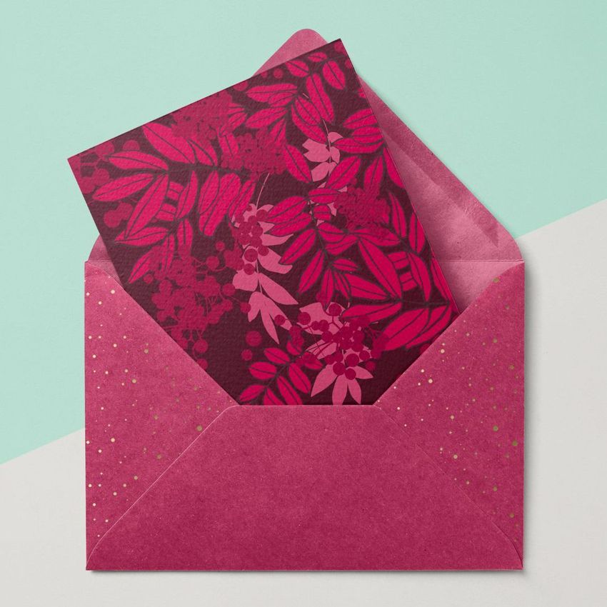 Metallic envelope mockup with a matching card featuring a red botanical pattern, displayed on a pastel geometric background.