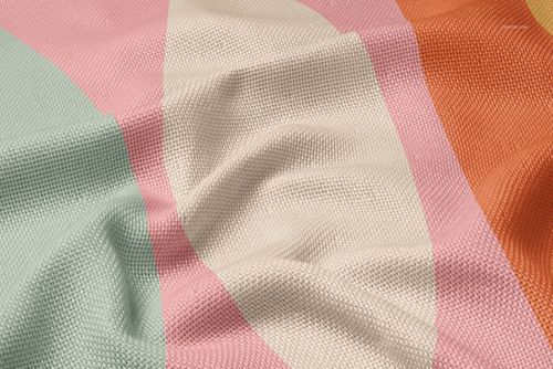 Woven polyester blanket mockup with pastel geometric pattern in pink, orange, green, and cream, close-up view.