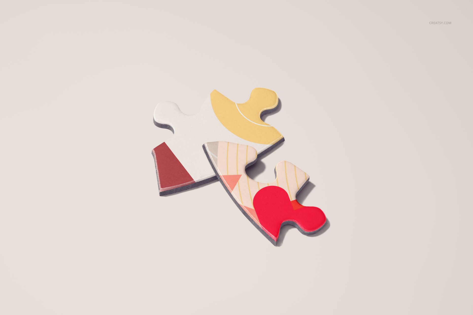 Heart jigsaw puzzle mockup featuring two interlocking pieces with abstract patterns and warm tones on a plain background.