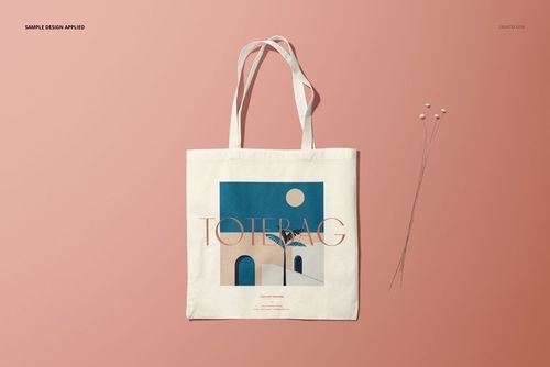 Tote bag mockup featuring a modern abstract design and long handles, displayed on a pastel pink surface with pins.