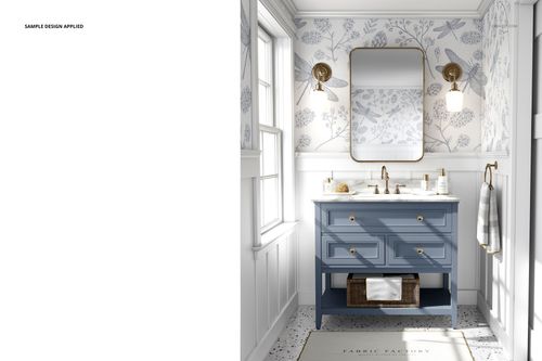 Front view of a bathroom mockup featuring a blue vanity, wall mirror, floral wallpaper, and brass sconces.
