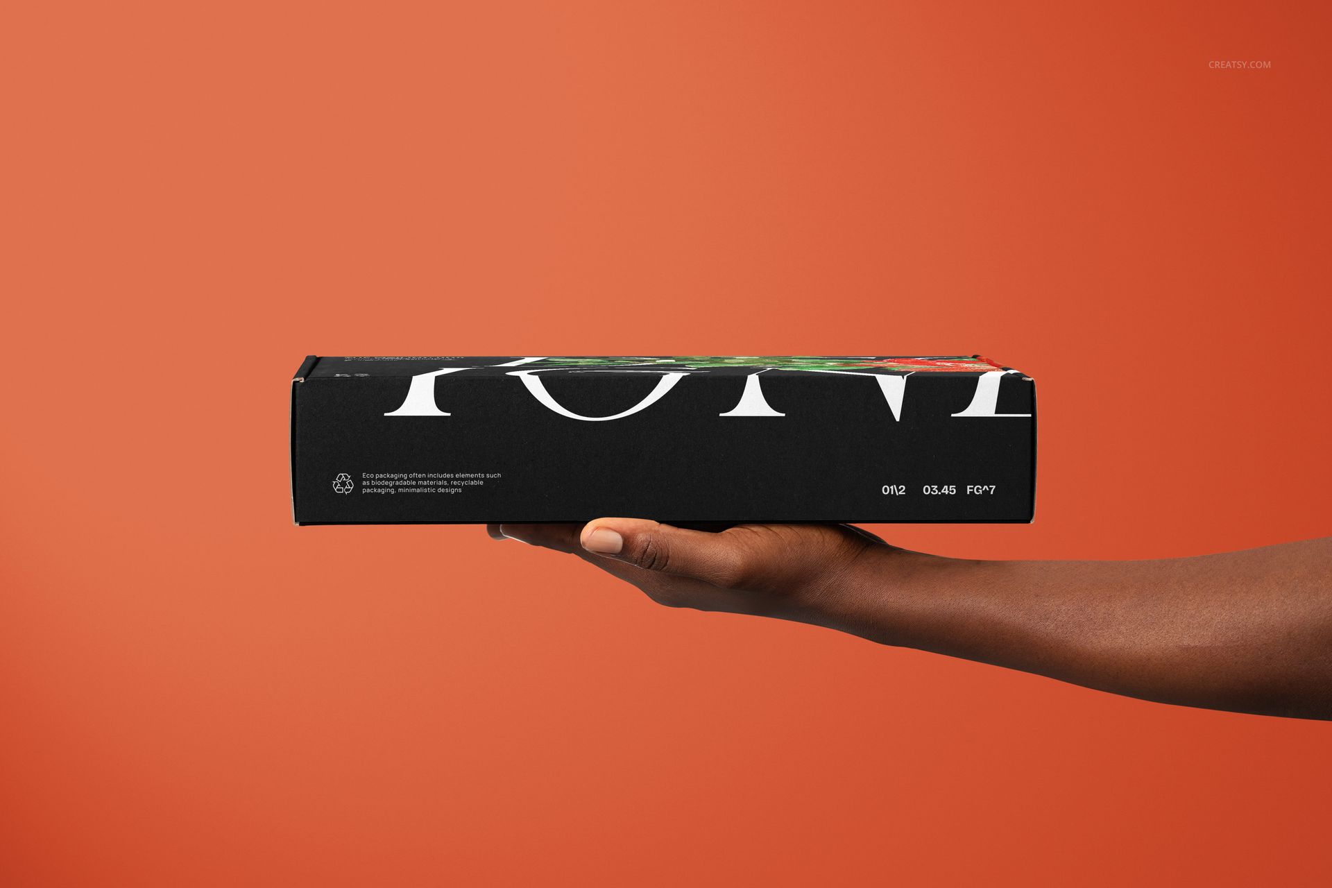 Black mailing box mockup featuring large white lettering, displayed horizontally in a hand with an orange backdrop.