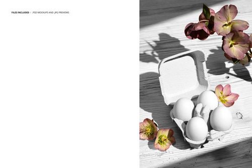 PSD mockup featuring an open carton of eggs and scattered hellebore flowers on a pale wooden background, overhead view.