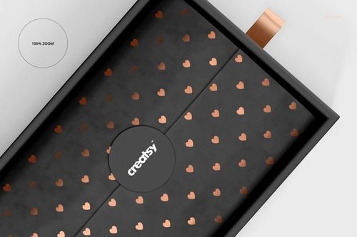 Rectangular gift box mockup with a black lid featuring a pattern of metallic heart shapes, shown from a top view.