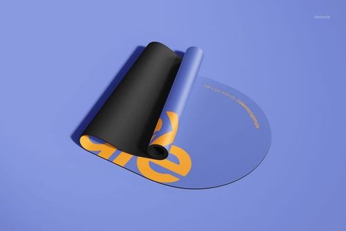 PSD mockup of an oval yoga mat partially rolled out, displaying a blue surface with orange lettering on a purple background.