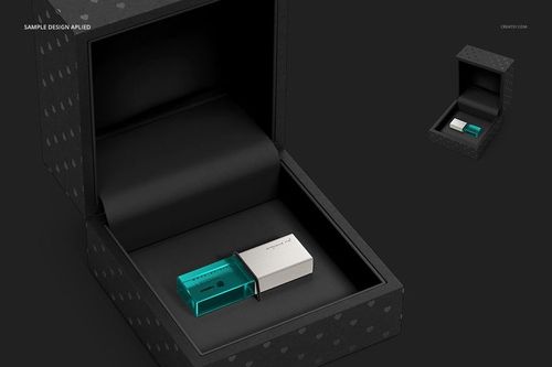 Front view of a black acrylic slide box mockup containing two USB drives in turquoise and white on a dark background.