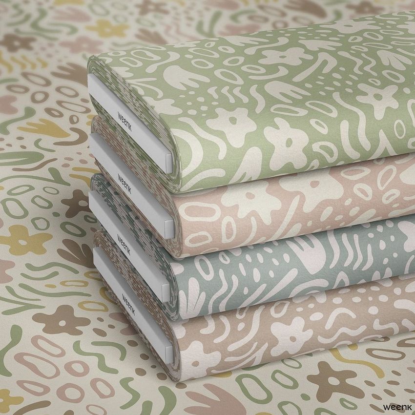 Fabric bolts mockup featuring four stacked bolts with abstract floral and botanical patterns in green, beige, and pastel tones.