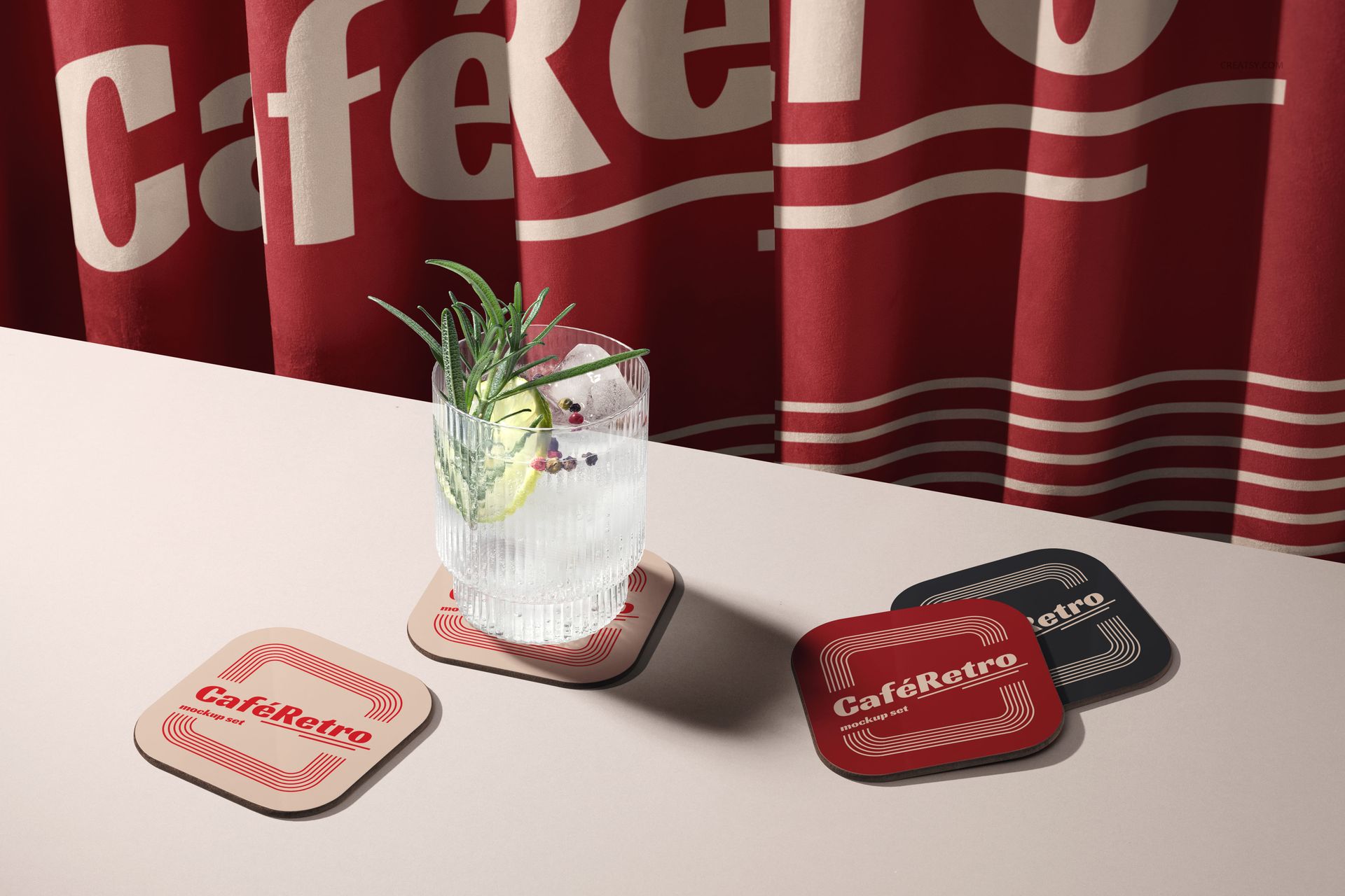 PSD mockup featuring vintage-inspired square coasters and a drink, set against a red curtain with bold lettering.