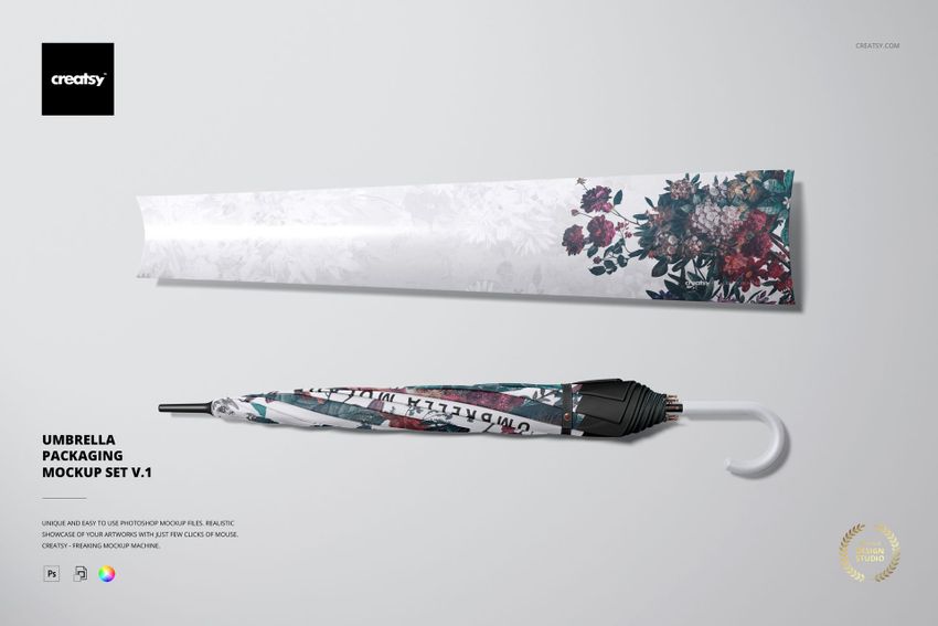 PSD mockup of a fashion accessory set with a folded umbrella and printed packaging, both decorated with vivid flower motifs.