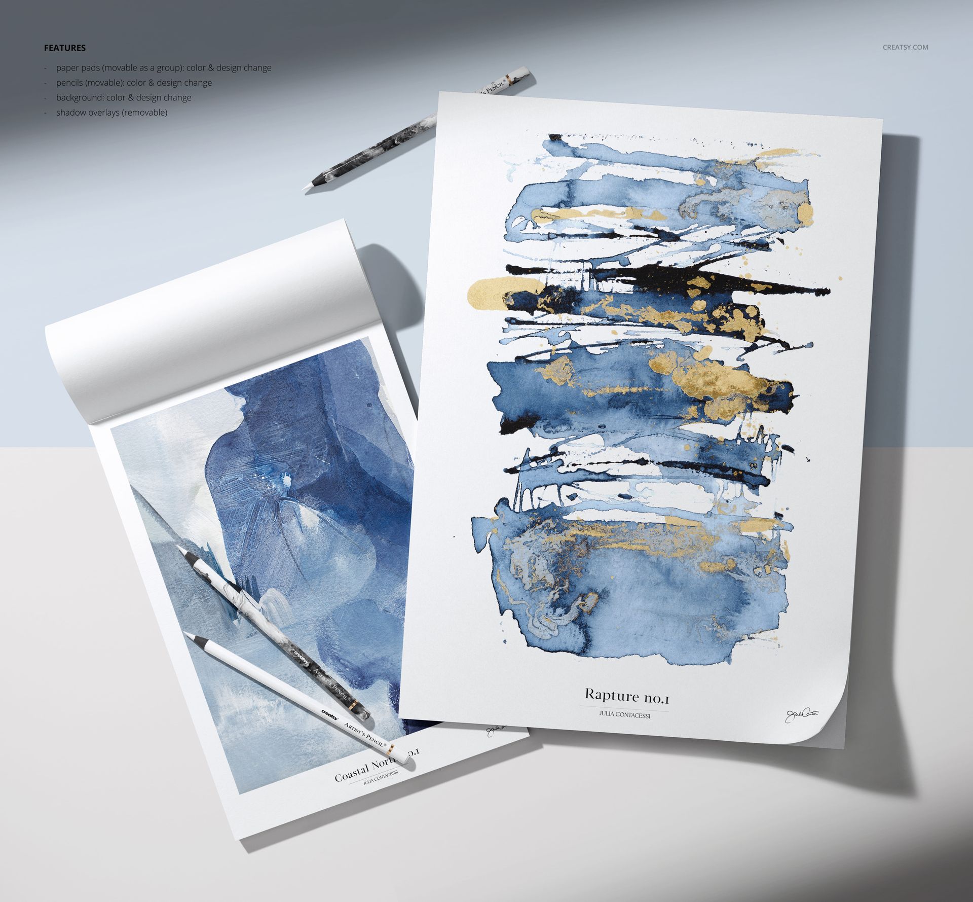 Art paper mockup set featuring two sheets with watercolor and mixed media artwork, pencils and brushes on a studio surface.