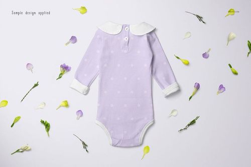 Long-sleeve baby romper mockup in light purple with white polka dots, shown from above on a white surface.