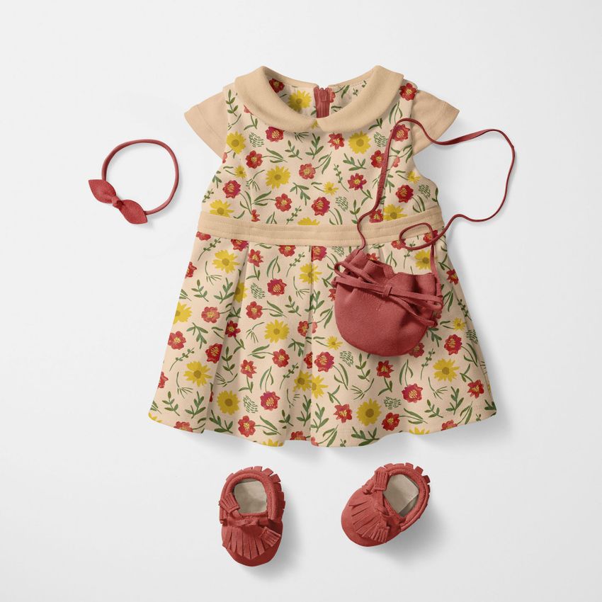 Peter Pan collar baby dress mockup with a watercolor floral pattern, shown flat with matching shoes, headband, and a small bag on a white background.