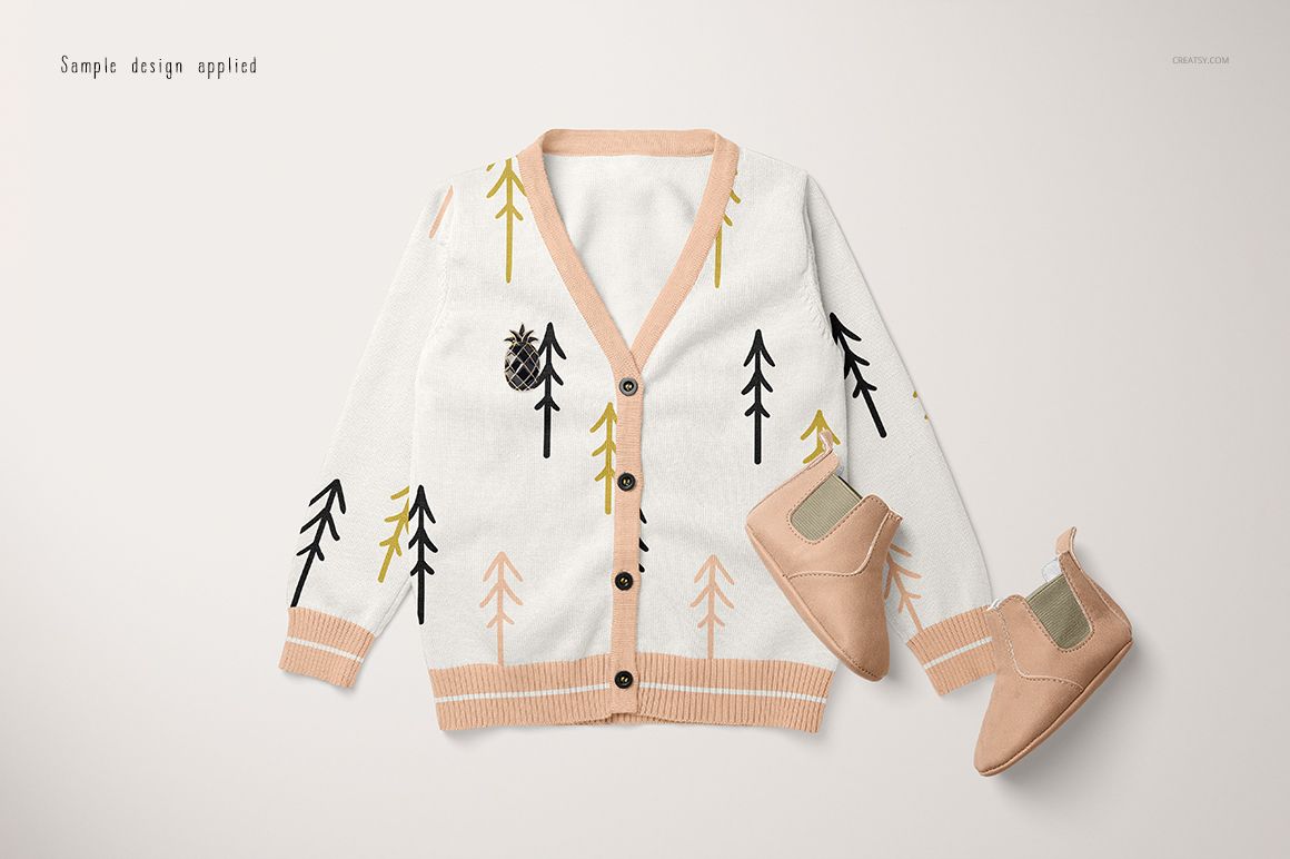 Baby cardigan sweater mockup featuring a white base with tree motifs and peach trim, displayed with matching shoes.