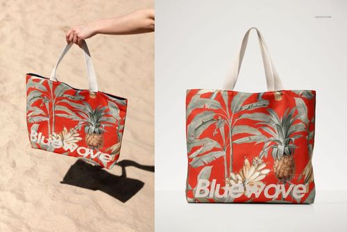 PSD mockup of a cotton tote bag featuring a bold red background and tropical plant design, displayed outdoors.