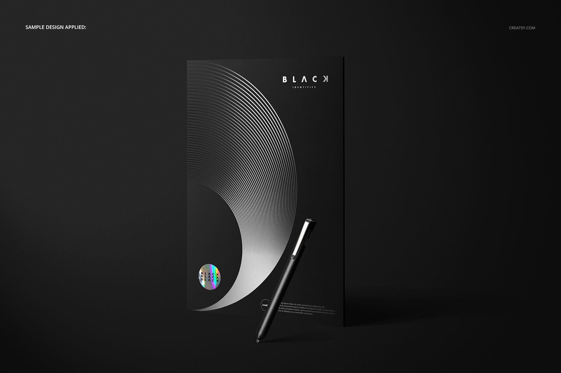 Front view of a black folder mockup with silver geometric circular pattern, accompanied by a black pen on a dark surface.