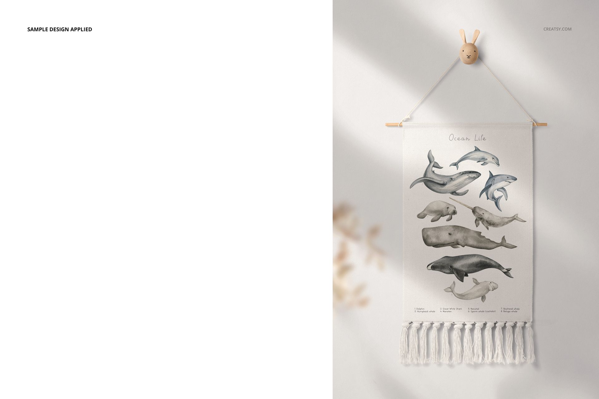 Front view of a mockup showing a fringed wall banner with illustrated sea creatures, displayed in a nursery setting.