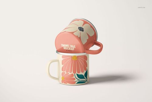 PSD mockup of two enamel mugs, each with silver rims and bold floral designs in pink and cream, shown from a front angle.