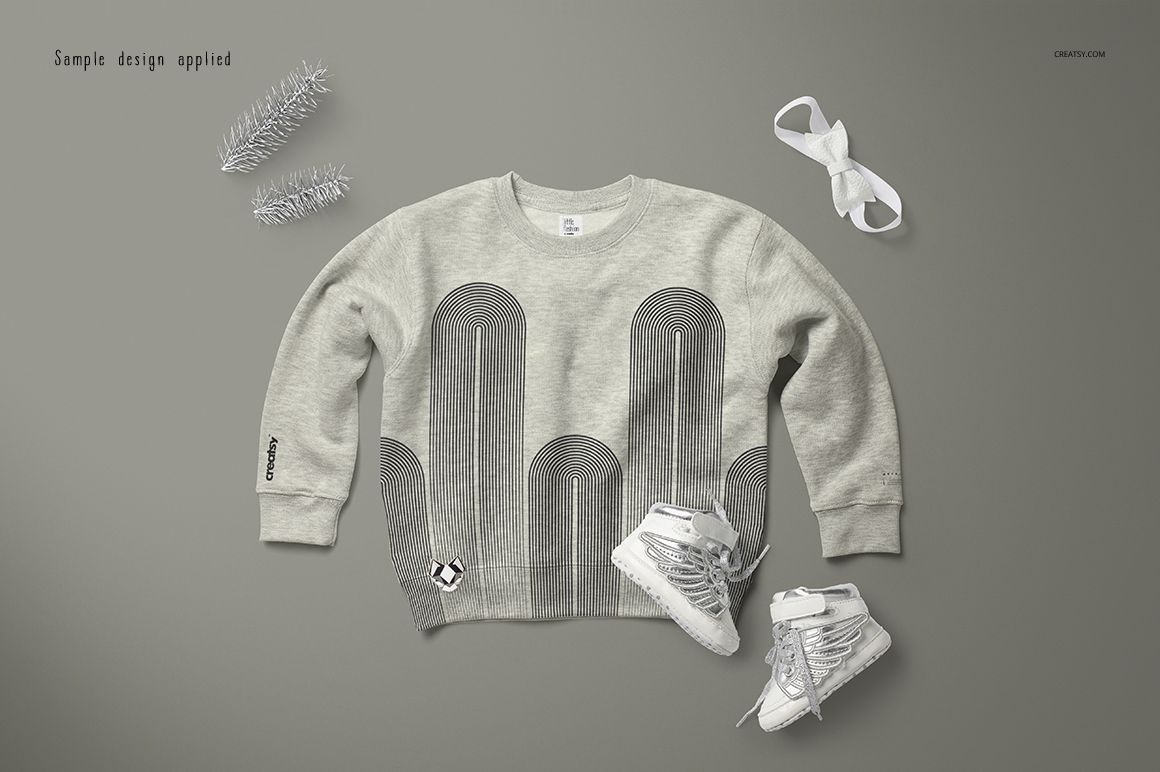 Heather baby sweatshirt mockup displayed flat, featuring a geometric gray pattern, with shoes and ribbon nearby.
